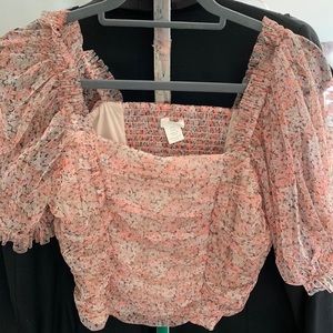 Flirty pastel pink top with a light floral print